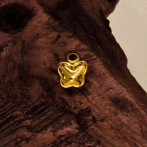 Pendentif papillon poli en acier inoxydable 304 posé sur un support en bois rustique