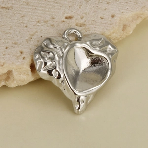 Macro shot of silver 304 stainless steel heart pendant with lava texture and smooth inlay