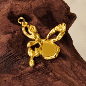 Artistic gold butterfly pendant with lava texture on dark wooden background for DIY necklaces