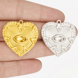 Creative 304 stainless steel heart pendant with embossed evil eye motif in gold and silver