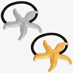Detail of 18k gold and silver starfish hair ties with textured finish and black elastic