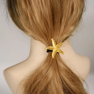 Élastique à cheveux étoile de mer dorée en acier inoxydable 304 sur les cheveux d'un modèle