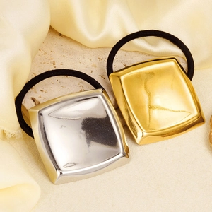 Detail of square curved 304 stainless steel hair ties in gold and silver mirror finish