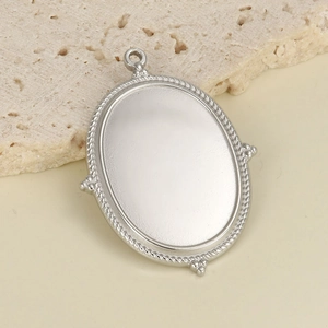 Vue macro du support pendentif ovale argenté avec bordure tressée et quatre points