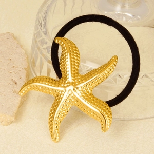 Black elastic hair tie with 18k gold starfish charm featuring textured metallic details