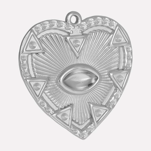 Macro detail of heart-shaped stainless steel pendant with radial lines and eye motif