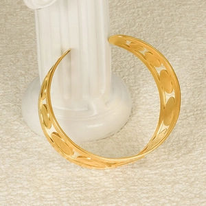 Polished 18K gold plated hollow geometric open collar necklace on a display stand