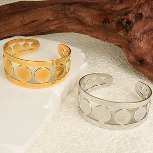 Detailed view of hollow circular pattern open bangles in 18K gold and silver finish