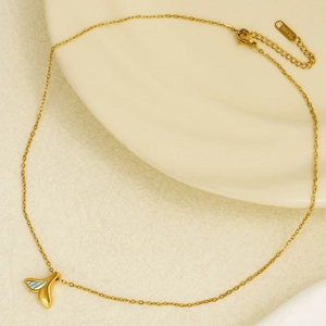 304 stainless steel gold necklace with a blue fishtail shell pendant on ceramic surface