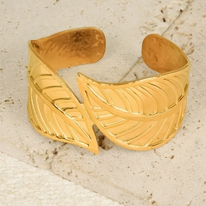 Detail of 18K gold plated leaf cuff bracelet showing intricate vein textures and hammer finish