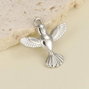 Macro detail of bird hummingbird pendant with polished finish and feather textures