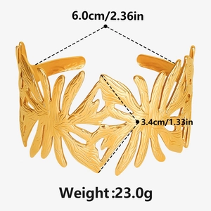 Detailed view of adjustable 18K gold plated cuff bracelet with tropical palm leaf texture