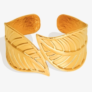 Detailed macro view of 18K gold plated leaf cuff bracelet with hammer-textured inner surface