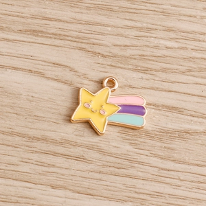 Macro view of a smiling yellow star pendant with colorful meteor tail for DIY crafts