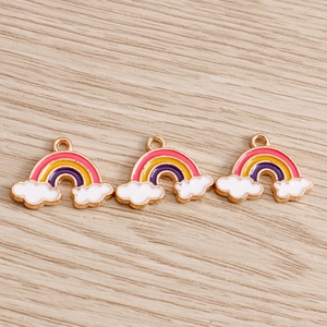 Detailed close-up of rainbow and cloud enamel charms for DIY jewelry and keychain making