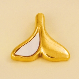 Macro detail of a 304 stainless steel whale tail pendant with white shell inlay