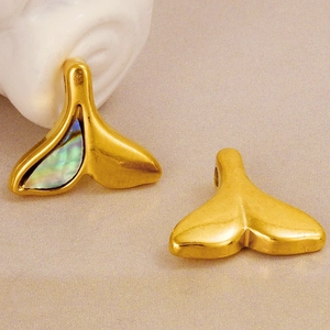Elegant 304 stainless steel fishtail necklace pendants with abalone shell inlay on beige fabric