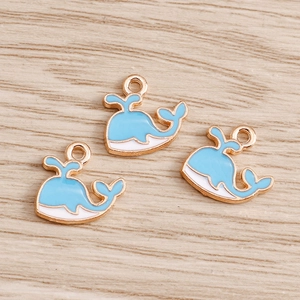 Gros plan détaillé de pendentifs baleines en émail bleu et blanc pour bijoux DIY