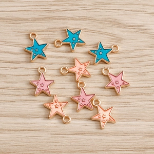 Colorful star-shaped enamel alloy pendants for DIY jewelry making on wood background