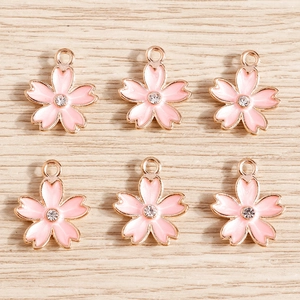 Pack of 10 pink enamel cherry blossom charms with gold trim for DIY jewelry making