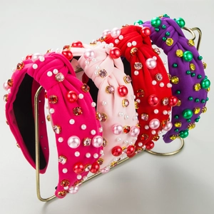 Detail of luxury padded headbands with pearls and crystals on a gold metal stand