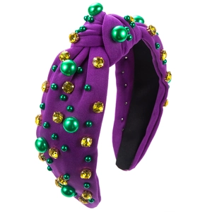 Detail of purple knotted headband with green pearls and yellow rhinestones