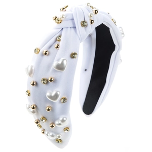 Detail of white knotted headband with heart pearls, gold studs and colorful rhinestones