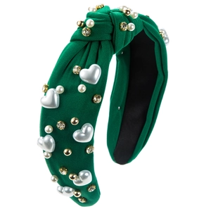 Detail of green knot headband with crystal rhinestones and heart pearl embellishments