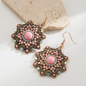 Detail shot of vintage western boho star earrings with pink turquoise and rhinestones