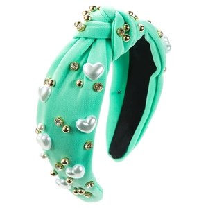 Detail of mint green knotted headband with heart pearls, gold beads and rhinestones