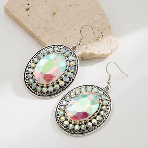 Macro shot of turquoise oval earrings with bohemian rhinestone accents and retro silver finish