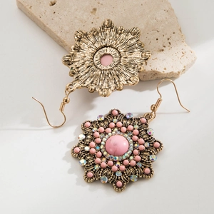 Detail view of Western style boho earrings with pink stone and sparkling rhinestones