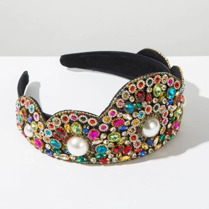 Close-up of luxury Baroque headband featuring colorful rhinestones and pearls on velvet