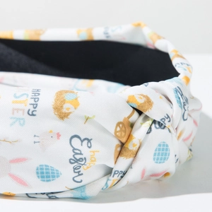 Detail of fabric knot on Easter headband featuring colorful egg and bunny print patterns