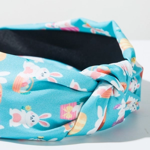 Close-up of sky blue knotted headband with Easter bunny and colorful egg patterns