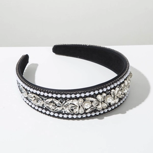 Close-up of vintage baroque headband with pearls and rhinestones on black fabric