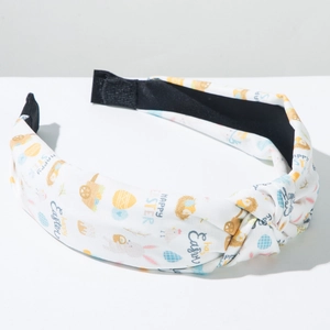 Detail view of Easter knotted headband with colorful egg and rabbit prints on white cotton