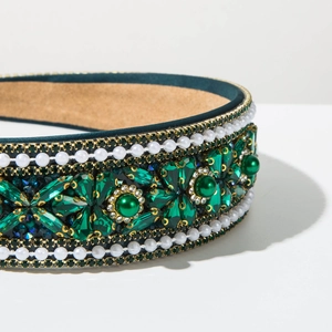 Detail of vintage Baroque headband featuring green rhinestones and white pearl embroidery