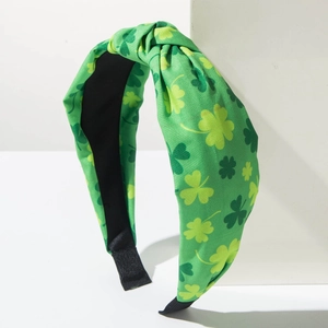Close-up of St. Patrick's Day wide knotted headband with green shamrock print fabric