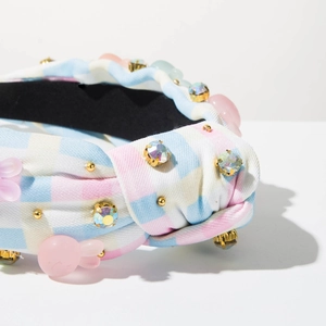 Detail of checkered headband with rhinestones, gold beads and pink resin rabbit accents