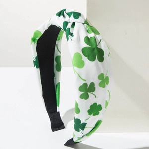 Close-up of Saint Patrick's Day headband with green clover patterns and top knot detail