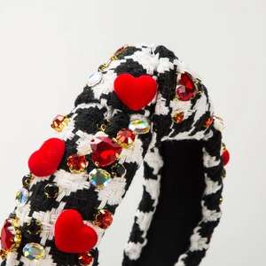 Detailed close-up of houndstooth headband with red flocked hearts and crystal rhinestones