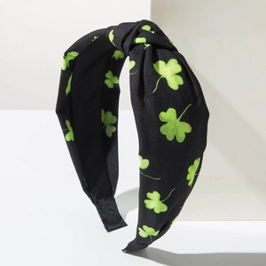 Detail of green shamrock pattern on black knotted headband for St. Patrick's Day