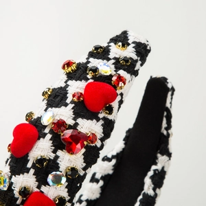 Macro shot of houndstooth headband with red velvet hearts and colorful rhinestones