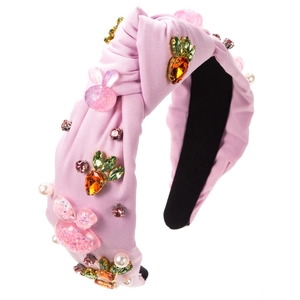 Detail of pink knotted headband featuring resin bunnies, crystal carrots and pearls