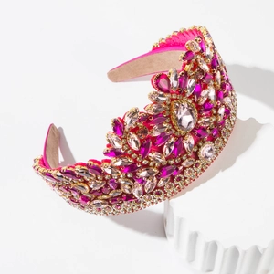 Close-up of pink baroque headband with multi-faceted rhinestones in gold claw settings