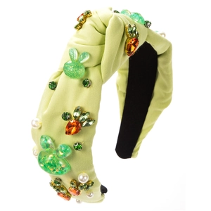 Detail view of lime green knot headband with bunny and carrot crystal embellishments