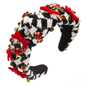 Detail of broad headband with black and white houndstooth fabric and red velvet bows