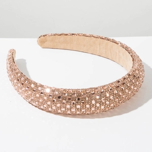 Close-up of thick Baroque headband with pink rhinestones and soft brown lining