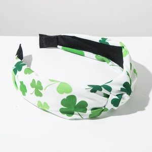 Detail of St. Patrick's Day headband with green shamrock pattern and central knot design